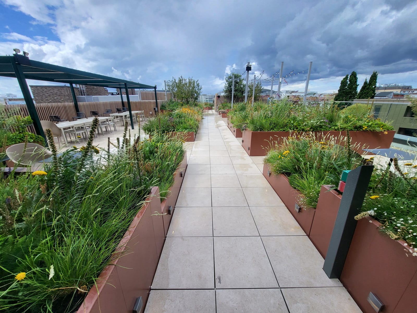 Raised planters lining a paved roof-terrace walkway at Bargate Quarter.